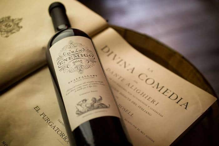 a bottle of the varietal Cabernet franch on a paper featuring the text of the Divine Comedy