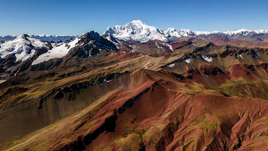 Red Valley with snowcoverd mountain, Rainbow Mountain and Red Valley
