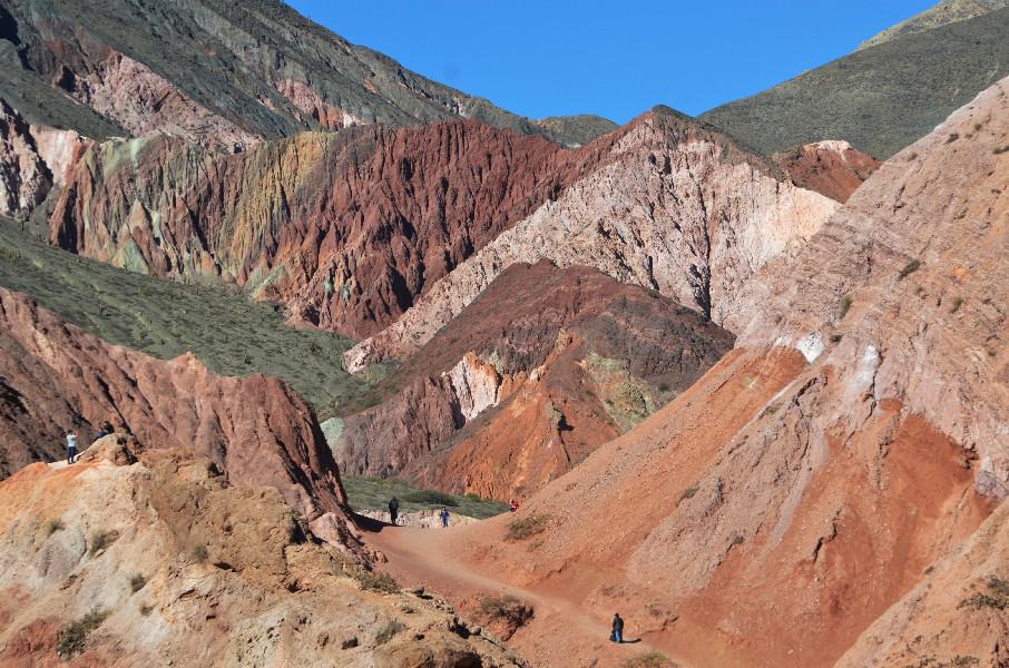 Behold the captivating landscape of Purmamarca's Seven Color Hill. Nestled in the heart of the Andes, this breathtaking sight showcases nature's artistic prowess. The hills, adorned with an enchanting palette of red, green, whitish, and brownish hues, create a mesmerizing tapestry of colors. Each slope tells a unique geological tale, formed over centuries by the forces of nature. As the sun casts its gentle rays, the vibrant shades come alive, painting a picturesque scene against the clear blue sky. The Seven Color Hill is a testament to the awe-inspiring beauty that can be found in the natural world.