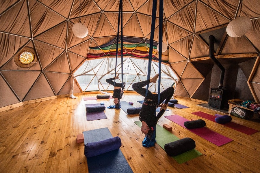 Yoga and aerial acrobatics with ribbons in one of EcoCamps domes in Torres del Paine, Patagonia