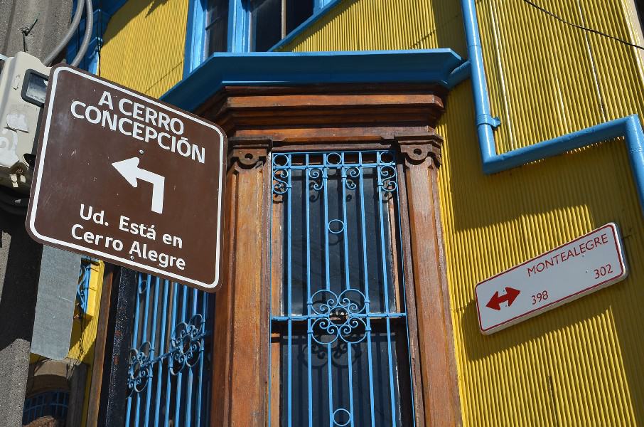 yellow building with street sign during the Valparaiso Walking and Wine Tasting Tour