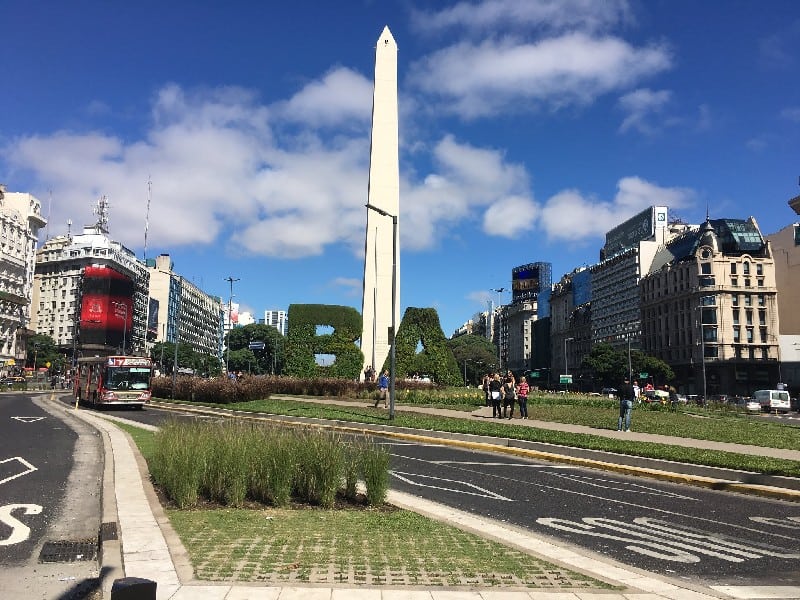 The iconic Buenos Aires Obelisk stands tall in the heart of the city. This picture captures its grandeur as it reaches towards the sky, symbolizing the rich history and vibrant spirit of the Argentine capital. Surrounded by bustling streets and bustling with life, the Obelisk serves as a prominent landmark, attracting both locals and tourists alike. Its white structure contrasts beautifully against the blue sky, making it a captivating sight to behold.