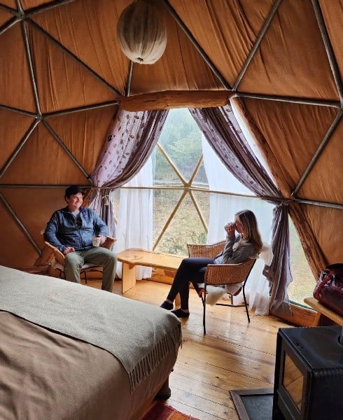 Enjoying a cup of tea and the view in the domes of EcoCamp in Torres del Paine, Patagonia