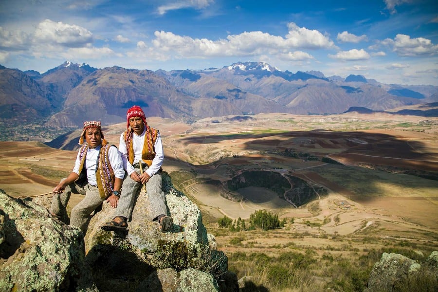 Local guides infront of an amazing view over Sacred Valley with the Moray terraces at the bottom of the Valley.