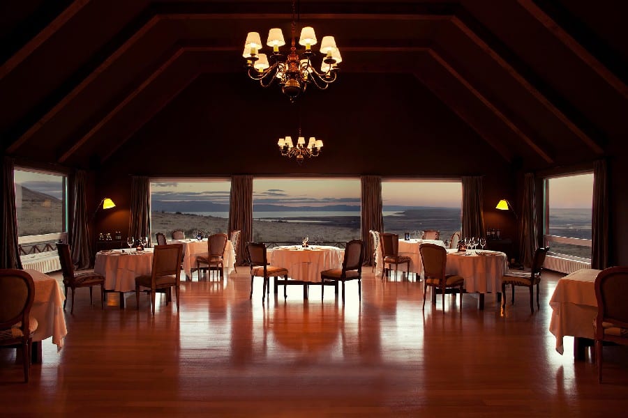 The dining room at Eolo Patagonia is a captivating space that immerses guests in refined elegance and natural beauty. Large windows surround the room, offering breathtaking panoramic views of the Patagonian landscape. The interior exudes warmth with its wooden furnishings and earthy tones, creating a cozy and inviting ambiance. Tables adorned with fine linens and elegant tableware are meticulously arranged, ready to welcome guests for a memorable dining experience. As visitors indulge in gourmet cuisine, they are treated to a feast for the senses, both inside the dining room and through the expansive windows that frame the remarkable Patagonian scenery.