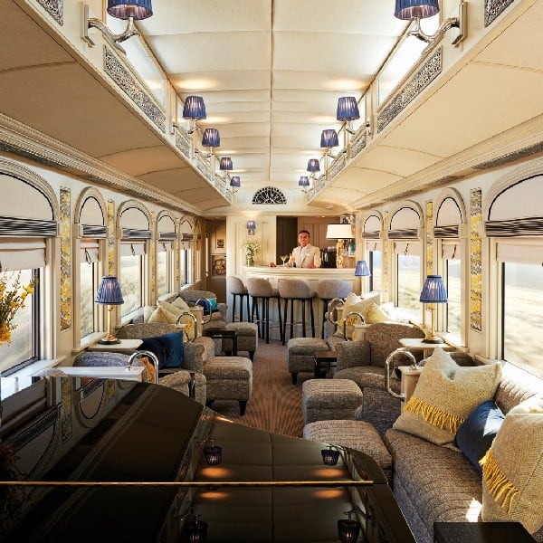 Luxury beige blue and grey wagon of the Andean Explorer with comfortable Seats, with a bar and professional barkeeper and a Piano.