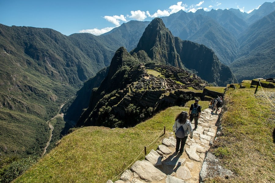 Picture taken on a blue sky day while walking down to Machu Picchu. overview over MaPi with the mountain and the green valley surrounding Machu Picchu.