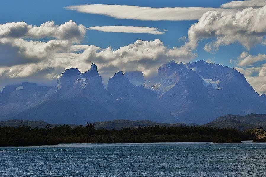 View over the lake with The Cordillera del Paine or Horns of Paine slightly cloud covered and in the background in Chilean Patagonia Torres del Paine National Park