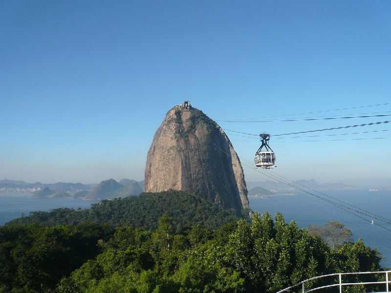 Experience the Thrilling Sugarloaf Cable Car Ride: A Must-See in Rio de Janeiro! Embark on an unforgettable journey aboard the Sugarloaf Cable Car in Rio de Janeiro, Brazil. The first leg takes you from Praia Vermelha to Morro da Urca, standing at 722 feet (220 m) above ground. From there, ascend to the summit of the magnificent Sugarloaf Mountain, reaching 1,299 feet (396 m). Originally envisioned by engineer Augusto Ferreira Ramos in 1908, this historic cableway, opened in 1912, was among the world's first. Today, it transports approximately 2,500 visitors daily, offering breathtaking views and thrilling adventures from 8 am to 10 pm.