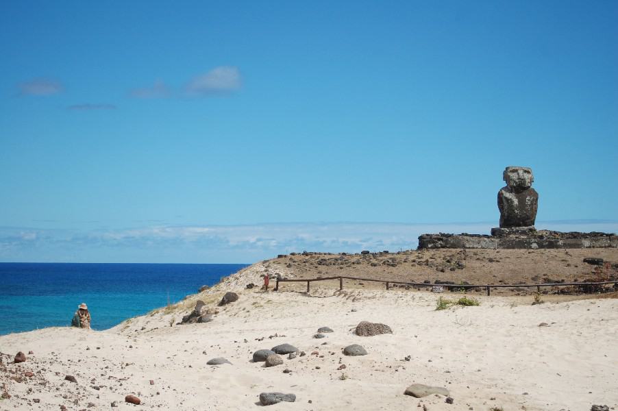 Anakena Beach with a Easter Island statue, the clear blue sky hitting the deep blue ocean at the horizon.