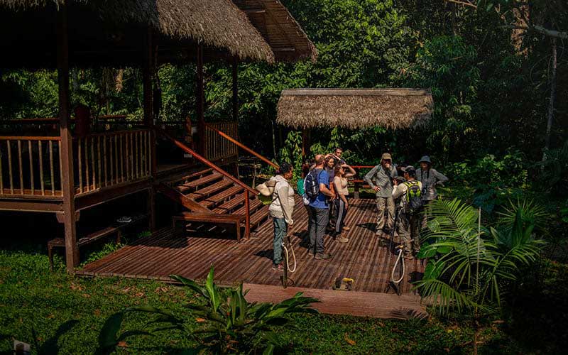 Guests at the entrance of Tambopata Research Center (TRC) in the Peruvian rainforest before leaving for an excursion