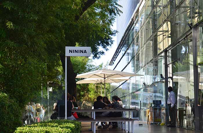 Cafe Malba's cafeteria ft. an outdoor terrace with trees 