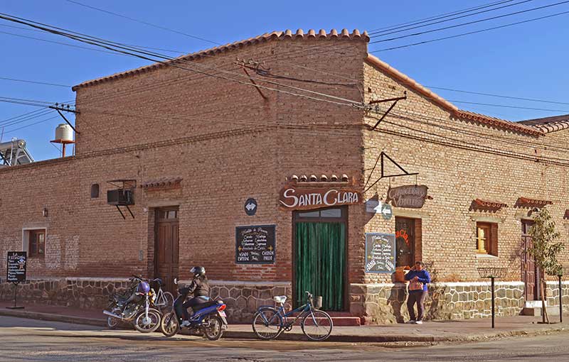 Salta Argentina - Typical house in Cayafate town, with pedestrians passing by