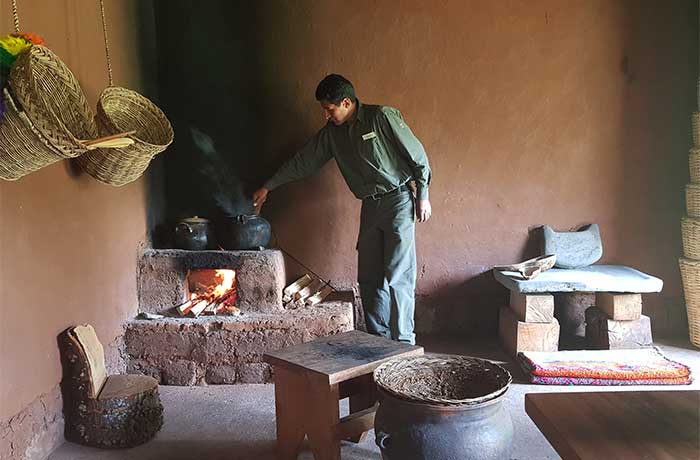 An Inkaterra guide cooking 'chicha' during a demo how to prepare maize beer in the Sacred Valley
