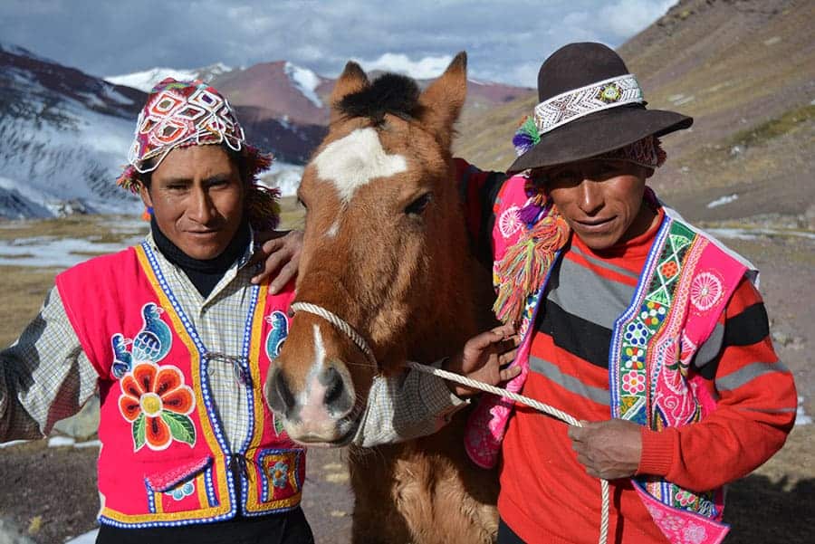 Shepherds with horse hiking the Rainbow Mountain Trail 