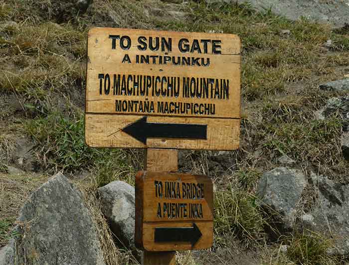 Sign at Machu Picchu showing the directions for Inti Punku path & Machu Picchu Mountain