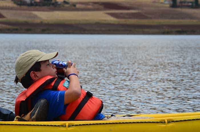 Kid doing kayaking at Huaypo Lake in the Sacred Valley of the Incas Cusco