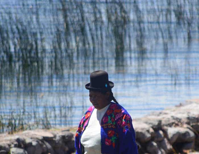 Lake Titicaca & Puno, lady of Luquina walking along the lake's shores 