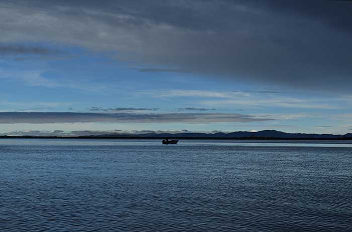 Lake Titicaca & Puno - fisherman sailing on the the lake at sunset