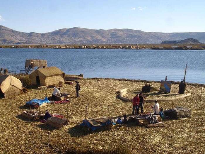 Lake Titicaca & Puno, Travelers buying handicrafts at one of the Uros Islands