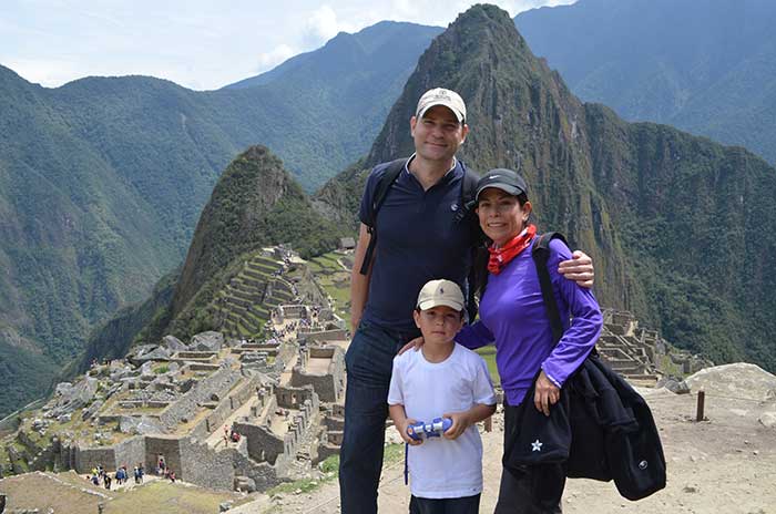 Machu Picchu with Kids, a family of three with Machu Picchu as backdrop