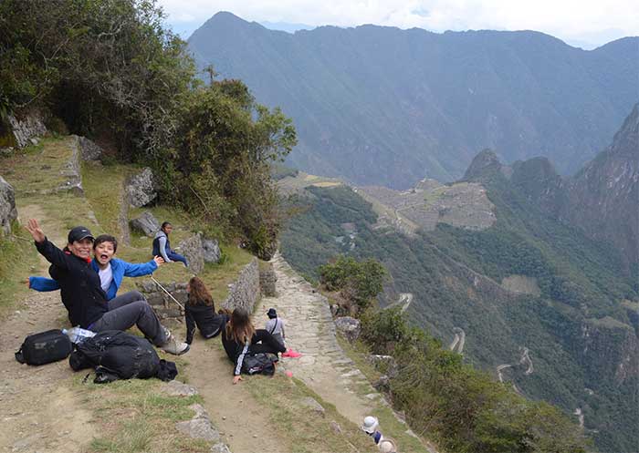 Machu Picchu With Kids, Mom & son sitting at Inti Punku (Sun Gate) with views of Machu Picchu 