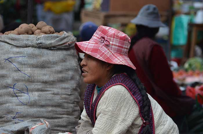 Local lady selling different sorts of potatoes at Pisaq Market in the Sacred Valley