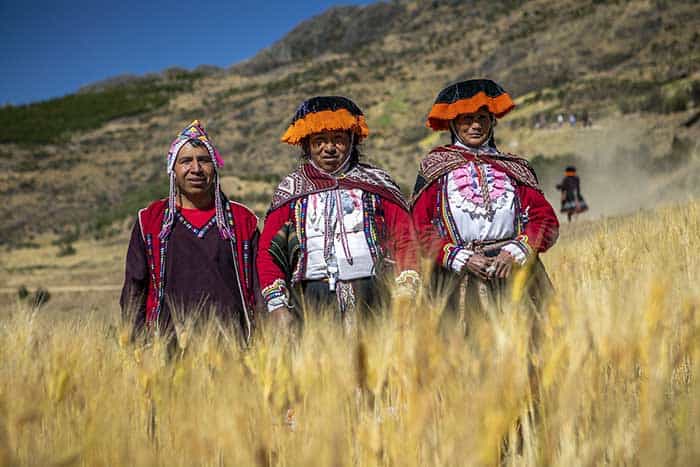 Two ladies in traditional attire and one man of the community of Paru Paru, Potato Park Peru