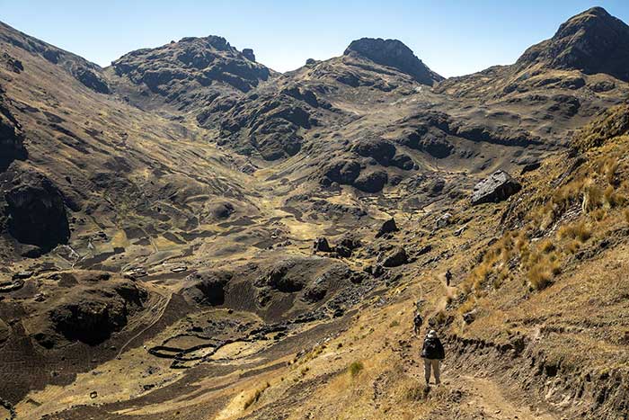 Three men hiking within the Potato Park in Cusco