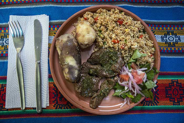 Main course served at the Potato Park consisting of steak, salad, 2 potatoes and quinoa side