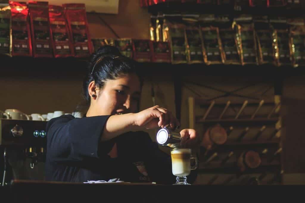 Lady serving coffee at Cafe Bar Casa del Corregidor in Puno