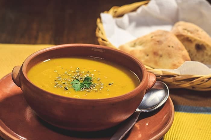 Vegetable soup made with fresh produce served with traditional bread at Cafe Bar Casa del Corregidor 