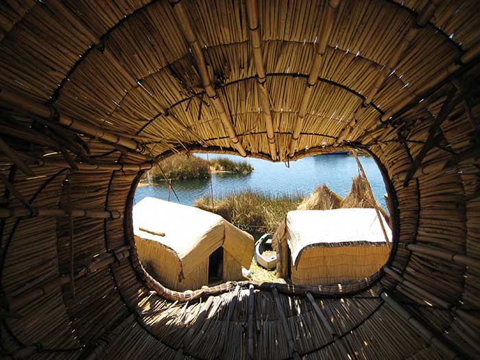 Lake Titicaca & Puno - Two reed houses on Uros islands viewed from a reed boat 