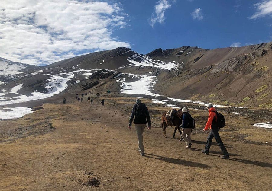 Hikers along the trail to get to Rainbow Mountain Vinicunca