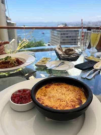 king crab pie served on a table overlooking the Pacific Ocean at La Concepcion in Valparaiso
