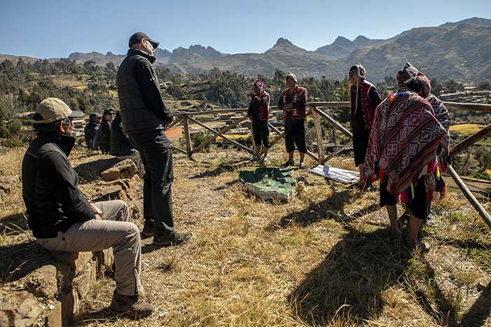 Tall man standing across the hosts of the Paru Paru community in the Potato Park - Peru