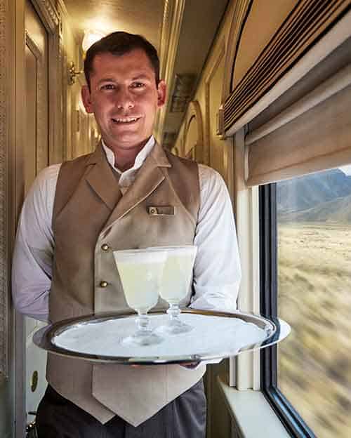 andean explorer dining car staff serving pisco sours