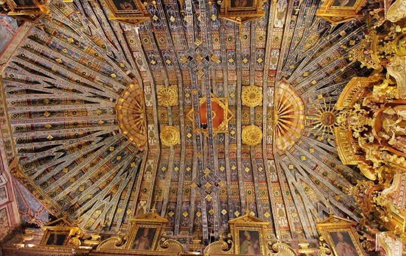 Colorful paintings on the artesonado ceiling of the Andahuaylillas church in Cusco