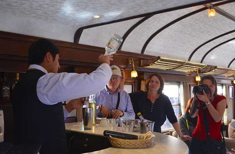 Barman preparing pisco sour on titicaca train