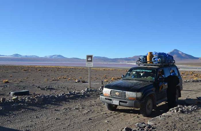 Jeep carrying water, gas supplies, bags, suitcases on the top in the Eduardo Avaroa hotel