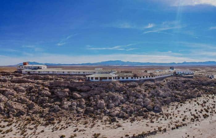 Aerial view from hotel Luna Salada in Colchani, Uyuni and the Andes as backdrop