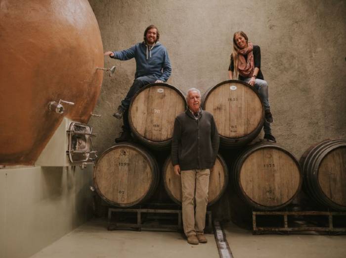 Father, son and daughter of the Morande family posing in the wine cellar of their Bodega Re, Casablanca Valley Chile