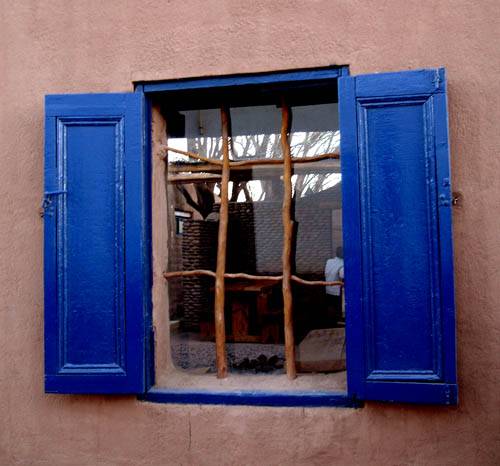 Typical blue window featuring tree branches in San Pedro de Atacama Chile