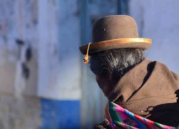 A lady wearing a traditional attire and hut in Uyuni 