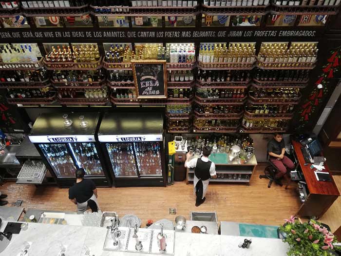 High shelves filled with bottles at Liguria Bistro & Bar, Santiago de Chile 
