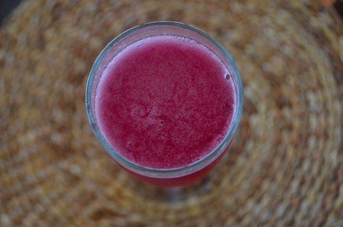 Pink Calafate Sour on a straw coaster