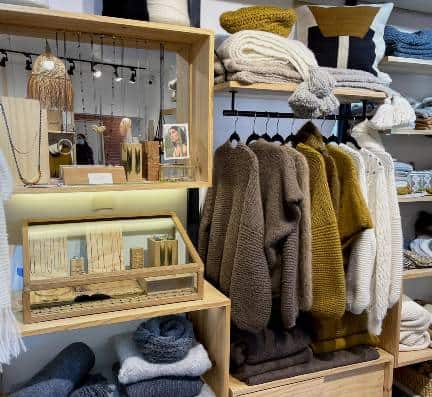 Alpaca jumpers, scarfs and jewelry displayed in a boutique store in Cusco